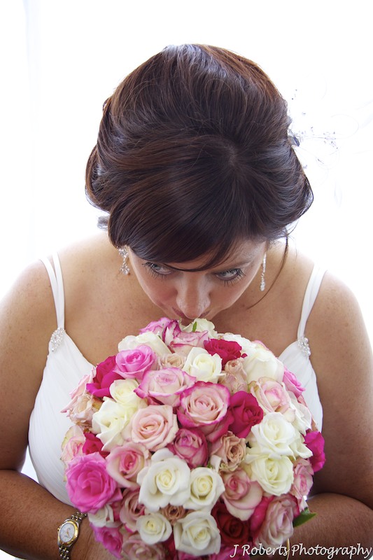 Bride smelling bridal bouquet by Show Posies - wedding photography sydney